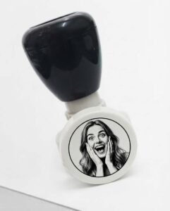 Self inking stamp with custom photo design pressed on paper